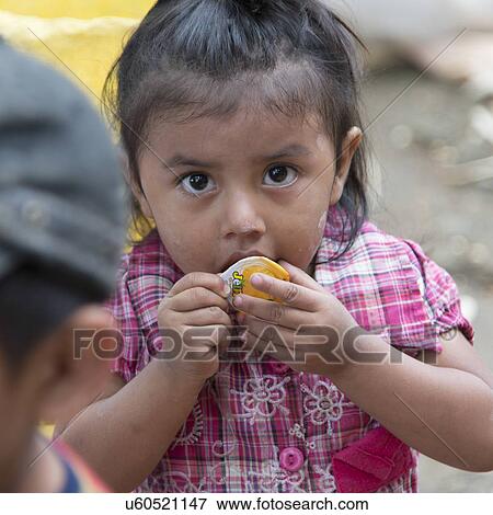 Closeup of a girl eating, Finca El Cisne, Honduras View Large Photo Image Stock Photo - Closeup of a girl eating, Finca El Cisne, Honduras. Fotosearch