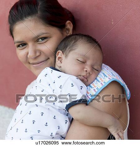 Closeup of a woman holding her baby, Copan, Copan Ruinas, Honduras View Large Photo Image Stock Photography - Closeup of a woman holding her baby, Copan, Copan Ruinas, Honduras. Fotosearch