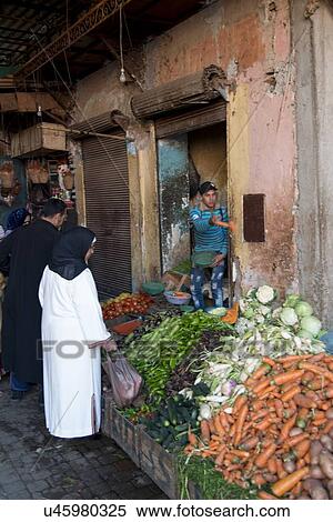 Customers buying vegetables on the street, Marrakesh, Morocco View Large Photo Image Stock Photography - Customers buying vegetables on the street, Marrakesh, Morocco. Fotosearch