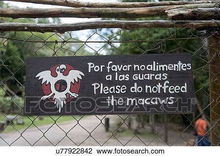 Stock Image - Do not feed macaw sign on a fence, Copan, Copan Ruinas, Copan Department, Honduras. Fotosearch