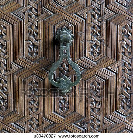Stock Photo - Doorknocker and carved detail of a door, Marrakesh Museum, Medina, Marrakesh, Morocco. Fotosearch