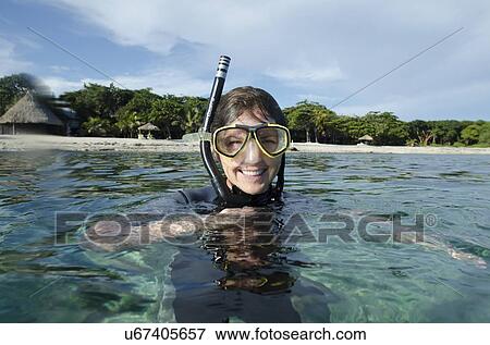 Stock Photo - Female scuba diver in the sea, Utopia Village, Utila, Bay Islands, Honduras. Fotosearch
