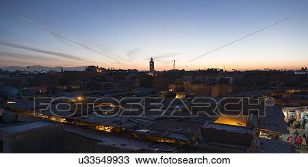 Stock Image - High angle view of city at dusk, Medina, Marrakesh, Morocco. Fotosearch
