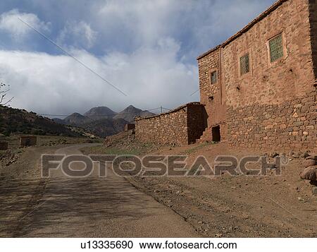 Stock Image - Houses along a road in village, Atlas Mountains, Morocco. Fotosearch
