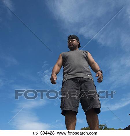 Low angle view of a man standing, Utila Island, Bay Islands, Honduras View Large Photo Image Stock Photo - Low angle view of a man standing, Utila Island, Bay Islands, Honduras. Fotosearch