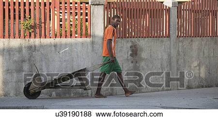 Man pulling a cart on the street, Cayman Cay, Utila Island, Bay Islands, Honduras View Large Photo Image Stock Photo - Man pulling a cart on the street, Cayman Cay, Utila Island, Bay Islands, Honduras. Fotosearch