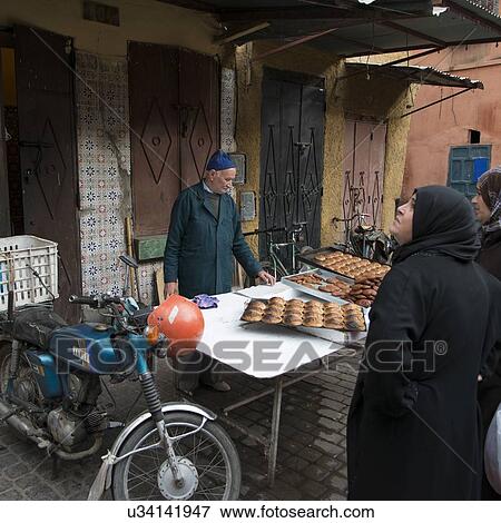 Stock Photo - Man selling breads in a market, Marrakesh, Morocco. Fotosearch