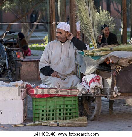 Stock Photograph - Man selling brooms on the street, Mellah, Marrakesh, Morocco. Fotosearch