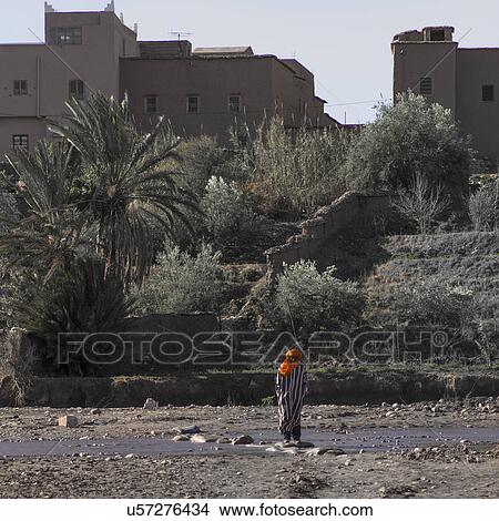 Picture - Man standing at river, Ait Benhaddou, Ouarzazate, Morocco. Fotosearch