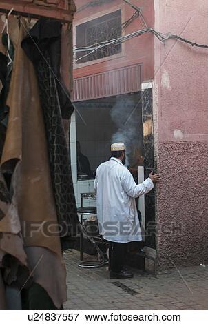 Man standing in front of a small restaurant, Marrakesh, Morocco View Large Photo Image Stock Photo - Man standing in front of a small restaurant, Marrakesh, Morocco. Fotosearch