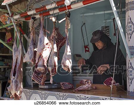 Man standing in the butchers shop in the souks, Morocco View Large Photo Image Stock Photograph - Man standing in the butchers shop in the souks, Morocco. Fotosearch
