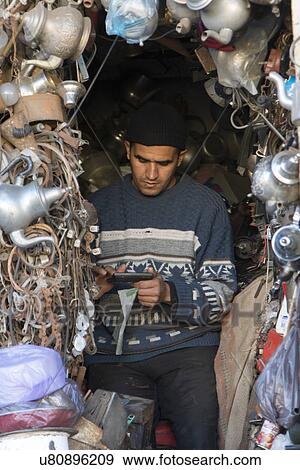 Man using a calculator in his antique shop, Kasbah Sidi Mansour, Marrakesh, Morocco View Large Photo Image Stock Photo - Man using a calculator in his antique shop, Kasbah Sidi Mansour, Marrakesh, Morocco. Fotosearch