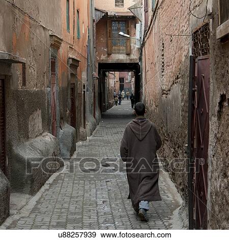 Man walking in a narrow street, Medina, Marrakesh, Morocco View Large Photo Image Stock Photo - Man walking in a narrow street, Medina, Marrakesh, Morocco. Fotosearch