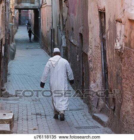 Stock Photography - Man walking on a street, Mellah, Medina, Marrakesh, Morocco. Fotosearch