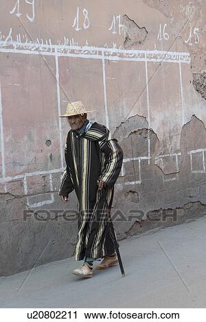 Stock Image - Man walking on the street, Mellah, Marrakesh, Morocco. Fotosearch