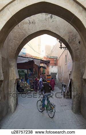 People near an archway on alley, Medina, Marrakesh, Morocco View Large Photo Image Stock Photo - People near an archway on alley, Medina, Marrakesh, Morocco. Fotosearch