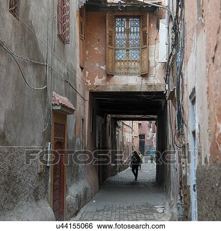 Stock Photograph - People walking in a narrow street, Medina, Marrakesh, Morocco. Fotosearch