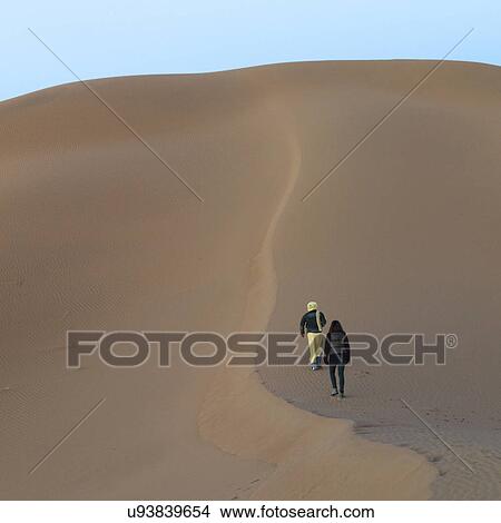 People walking on Erg Chegaga Dunes in Sahara Desert, Souss-Massa-Draa, Morocco View Large Photo Image Picture - People walking on Erg Chegaga Dunes in Sahara Desert, Souss-Massa-Draa, Morocco. Fotosearch
