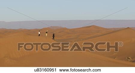 People walking on Erg Chegaga Dunes in Sahara Desert, Souss-Massa-Draa, Morocco View Large Photo Image Stock Image - People walking on Erg Chegaga Dunes in Sahara Desert, Souss-Massa-Draa, Morocco. Fotosearch