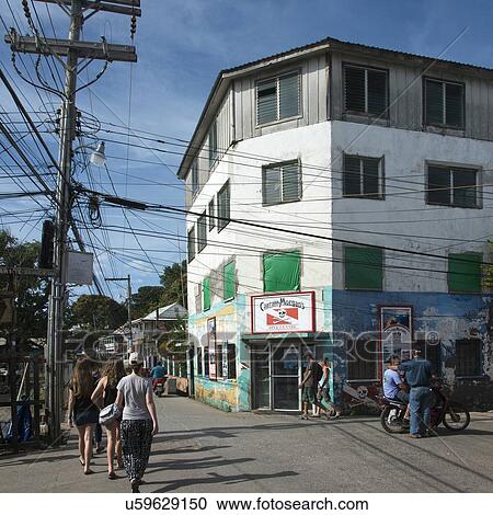 People walking on the road in a town, Utila Island, Bay Islands, Honduras View Large Photo Image Stock Image - People walking on the road in a town, Utila Island, Bay Islands, Honduras. Fotosearch