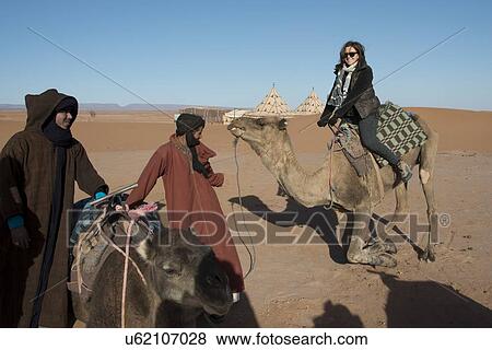 People with camels in a desert, Erg Chigaga Luxury Desert Camp, Sahara Desert, Souss-Massa-Draa, Morocco View Large Photo Image Stock Photo - People with camels in a desert, Erg Chigaga Luxury Desert Camp, Sahara Desert, Souss-Massa-Draa, Morocco. Fotosearch