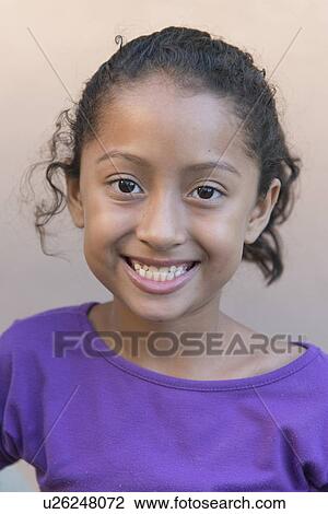 Stock Image - Portrait of a girl smiling, Utila, Bay Islands, Honduras. Fotosearch