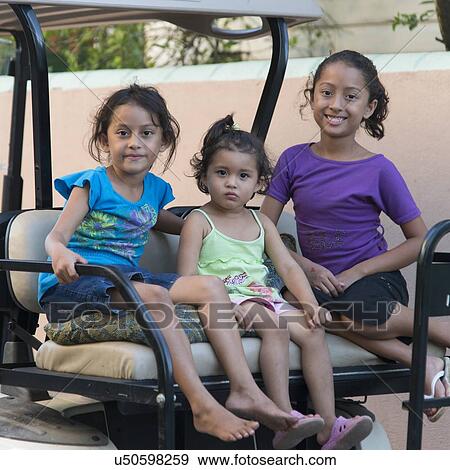 Stock Photo - Portrait of three girls sitting together and smiling, Utila, Bay Islands, Honduras. Fotosearch