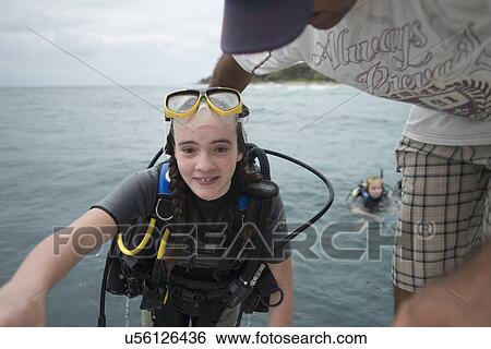 Stock Photograph - Scuba diver return back to the boat, Utila, Bay Islands, Honduras. Fotosearch