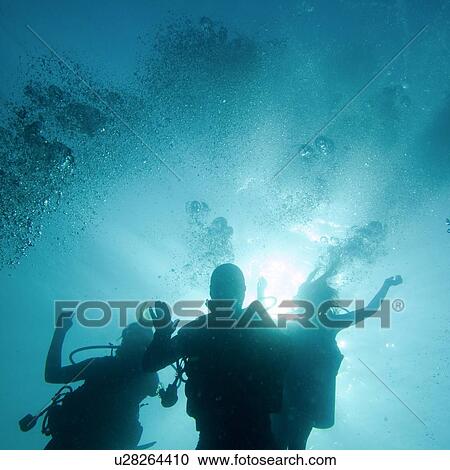 Stock Image - Scuba divers underwater, Utila, Bay Islands, Honduras. Fotosearch