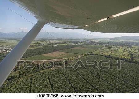 Seaplane flying over agricultural fields, Bay Islands, Honduras View Large Photo Image Stock Photo - Seaplane flying over agricultural fields, Bay Islands, Honduras. Fotosearch