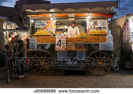 Stock Photograph - Street vendor selling fruits in a market, Djemma El Fna, Marrakesh, Morocco. Fotosearch