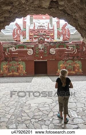 Stock Image - Teenage girl entering the archaeological museum through a tunnel, Copan, Copan Ruinas, Honduras. Fotosearch