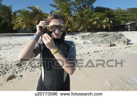 Stock Photograph - Teenage girl with scuba mask on the beach, Utila, Bay Islands, Honduras. Fotosearch