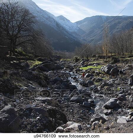 Stock Photo - Tourists at stream in a valley, Imlil, Atlas Mountains, Morocco. Fotosearch
