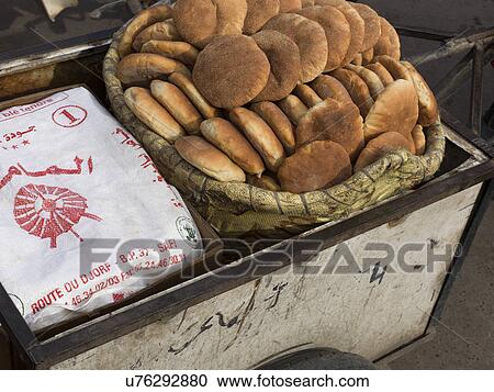 Stock Image - Traditional breads for sale at a market, Arset El Maach, Marrakesh, Morocco. Fotosearch