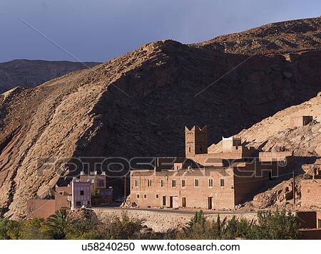 Stock Image - Traditional building in town at mountainside, Ouarzazate, Morocco. Fotosearch