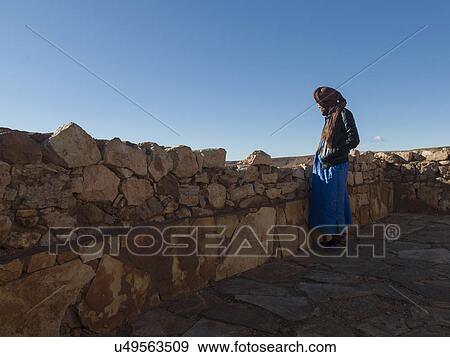 Stock Photo - Tuareg man standing at the terrace of a fort, Ait Benhaddou, Ouarzazate, Souss-Massa-Draa, Morocco. Fotosearch