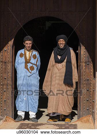 Two men standing at the entrance of a building, Ouarzazate, Souss-Massa-Draa, Morocco View Large Photo Image Picture - Two men standing at the entrance of a building, Ouarzazate, Souss-Massa-Draa, Morocco. Fotosearch