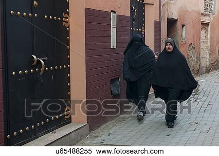 Stock Photography - Two women walking on the street, Morocco. Fotosearch
