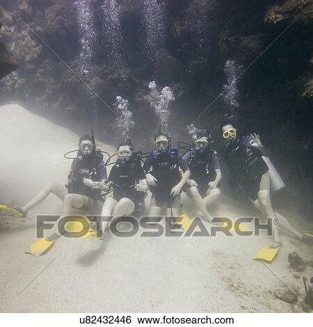 Underwater view of scuba divers on sea floor, Utila, Bay Islands, Honduras View Large Photo Image Stock Photograph - Underwater view of scuba divers on sea floor, Utila, Bay Islands, Honduras. Fotosearch