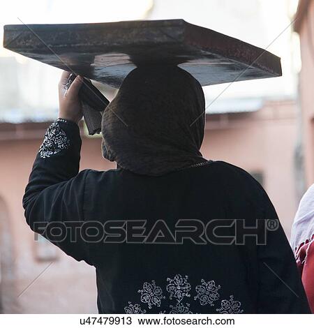 Woman carrying tray on head, Medina, Marrakesh, Morocco View Large Photo Image Stock Image - Woman carrying tray on head, Medina, Marrakesh, Morocco. Fotosearch