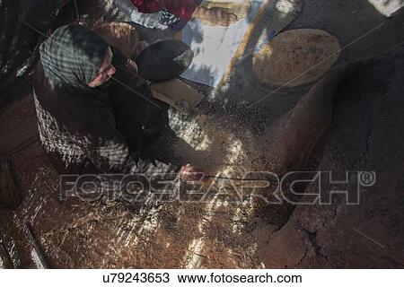 Woman cooking traditional bread on mud oven, Tabounte, Ouarzazate Province, Souss-Massa-Draa, Morocco View Large Photo Image Stock Image - Woman cooking traditional bread on mud oven, Tabounte, Ouarzazate Province, Souss-Massa-Draa, Morocco. Fotosearch