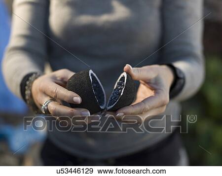 Stock Photo - Woman holding two halves of Amethyst stone with quartz inside, Atlas Mountains, Morocco. Fotosearch