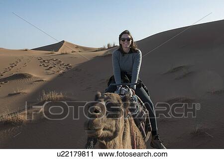 Woman riding a camel in Erg Chegaga Dunes, Sahara Desert, Souss-Massa-Draa, Morocco View Large Photo Image Stock Image - Woman riding a camel in Erg Chegaga Dunes, Sahara Desert, Souss-Massa-Draa, Morocco. Fotosearch