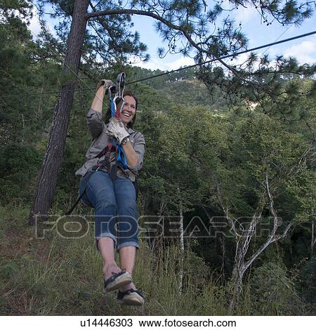Woman riding a zip line in a forest, Copan, Copan Ruinas, Copan Department, Honduras View Large Photo Image Stock Image - Woman riding a zip line in a forest, Copan, Copan Ruinas, Copan Department, Honduras. Fotosearch
