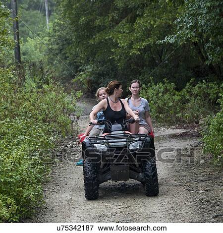 Woman riding quadbike with her teenage daughters on dirt road, Utila, Bay Islands, Honduras View Large Photo Image Stock Photo - Woman riding quadbike with her teenage daughters on dirt road, Utila, Bay Islands, Honduras. Fotosearch