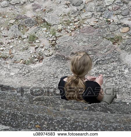 Woman sitting on steps at an archaeological site, Copan, Copan Ruinas, Copan Department, Honduras View Large Photo Image Stock Image - Woman sitting on steps at an archaeological site, Copan, Copan Ruinas, Copan Department, Honduras. Fotosearch