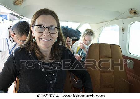 Picture - Woman smiling in a seaplane, Bay Islands, Honduras. Fotosearch