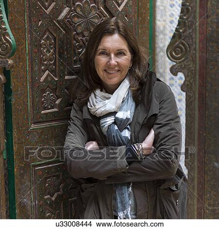 Picture - Woman standing at the doorway of Kasbah of Glaoui, Telouet, Ouarzazate, Souss-Massa-Draa, Morocco. Fotosearch