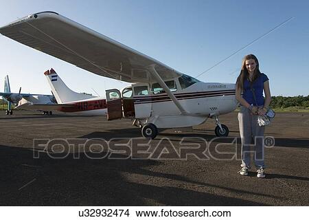 Picture - Woman standing in front of seaplanes, Bay Islands, Honduras. Fotosearch